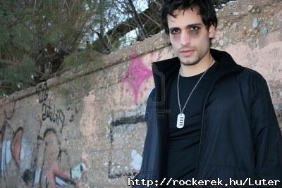 2472283-young-man-in-gothic-look-lying-on-a-wall