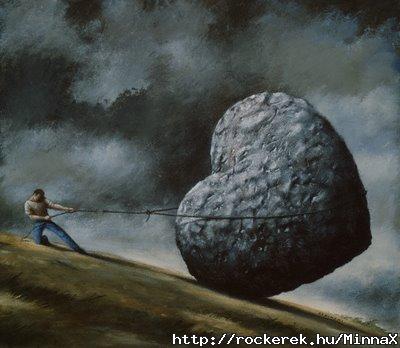 rope-breaking-on-man-holding-stone-heart-on-hillside